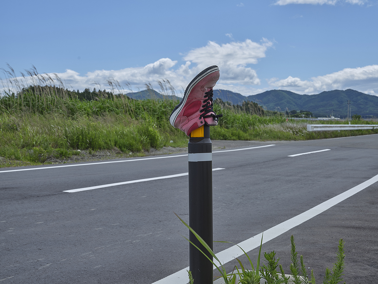 Two stations, a shoe, and a railroad crossing